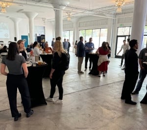 Attendees standing at high tops during Epic + USGBC event