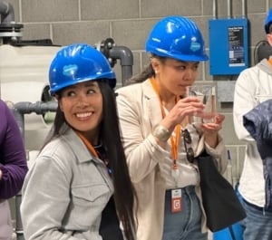 A tour participant smells recycled water to see there is no scent